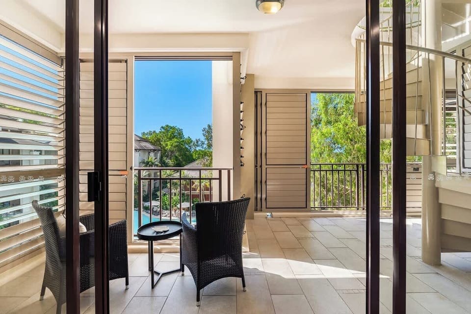Your private balcony offers serene pool views.