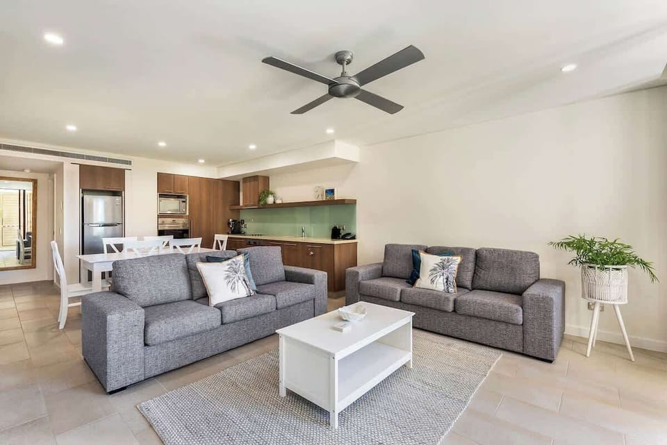 Relax in the spacious and airy living area with a ceiling fan.