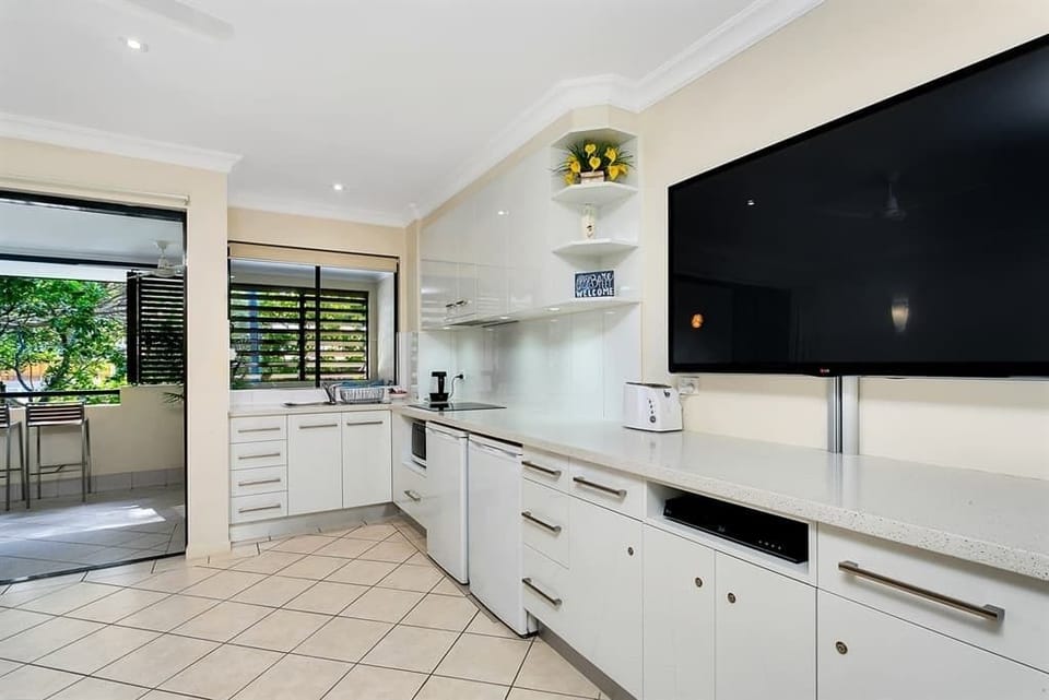 The open plan living and dining area extends to a private balcony with leafy outlooks.