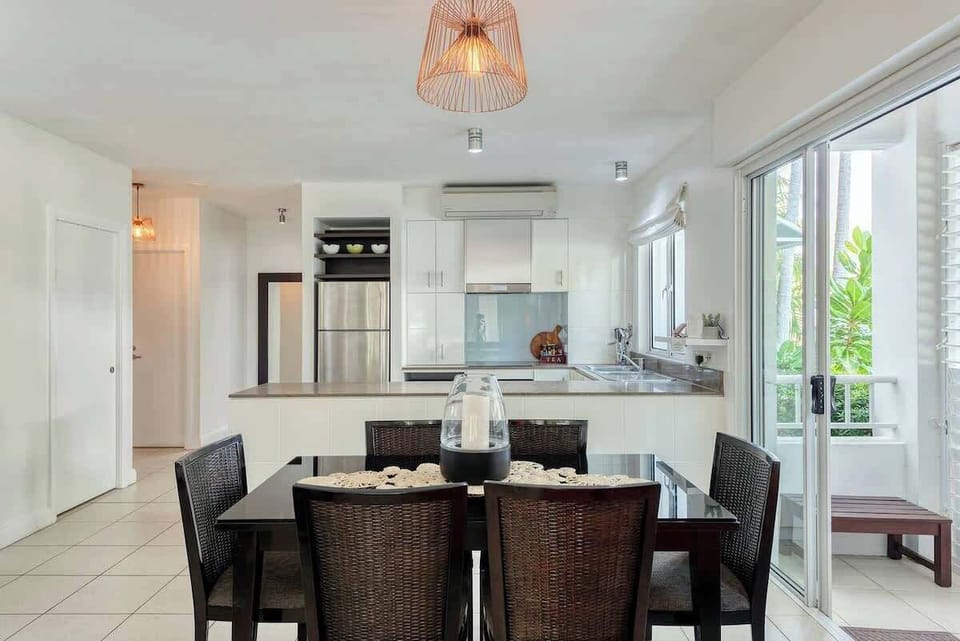 Staying in? Preparing meals at home is easy with a well-equipped kitchen and six-seater table. Air conditioning keeps the apartment comfortable year-round.