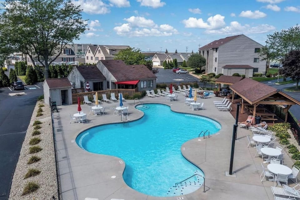 Pool area including hot tub, gas grills and picnic areas.