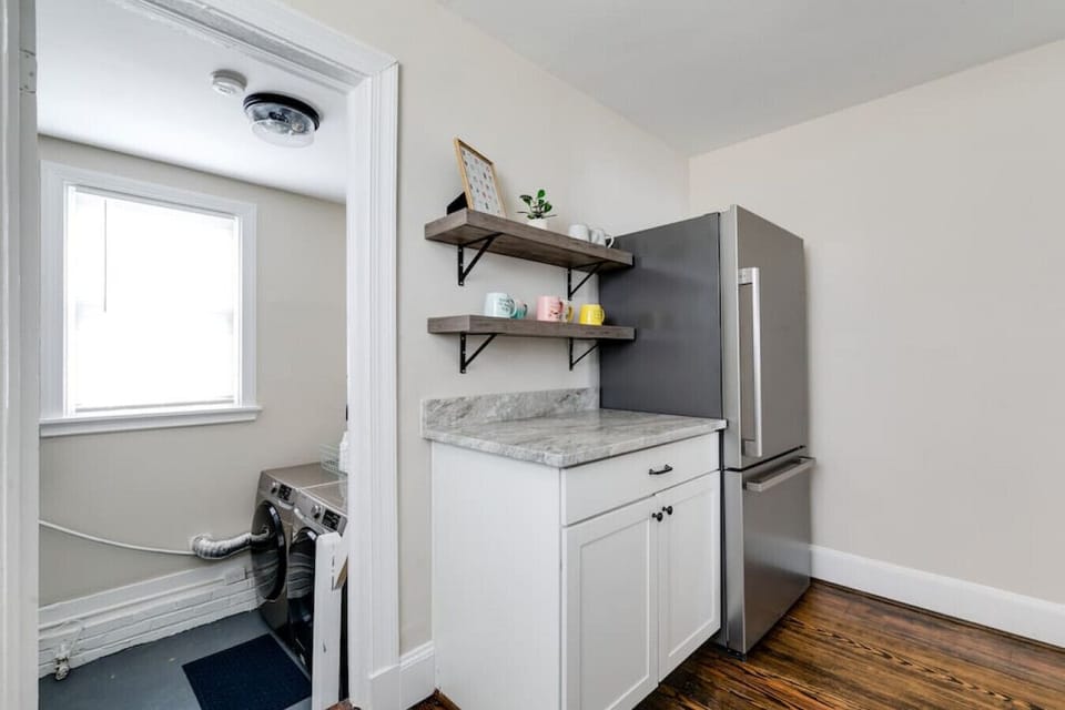 Fully equipped with all the essentials, including a microwave, dishwasher, Keurig Duo coffee maker, and funky coffee cups. Plenty of counter space and cozy charm make cooking a delight!  Laundry area conveniently located off the kitchen!