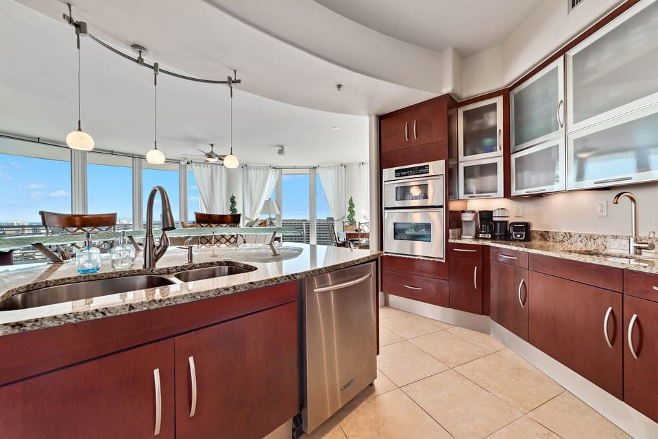 Imagine preparing delicious meals with ease in this well-appointed kitchen, all while staying connected with family and friends in the adjacent living and dining areas. This open-concept design is ideal for a relaxed coastal lifestyle.