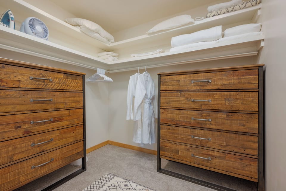 Master walk-in closet with plenty of drawer space, extra bedding, fans and iron.