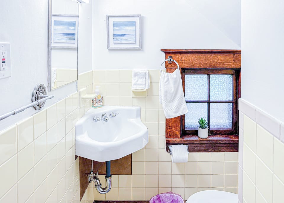 Step into a quaint and character-filled bathroom boasting a wooden accents.