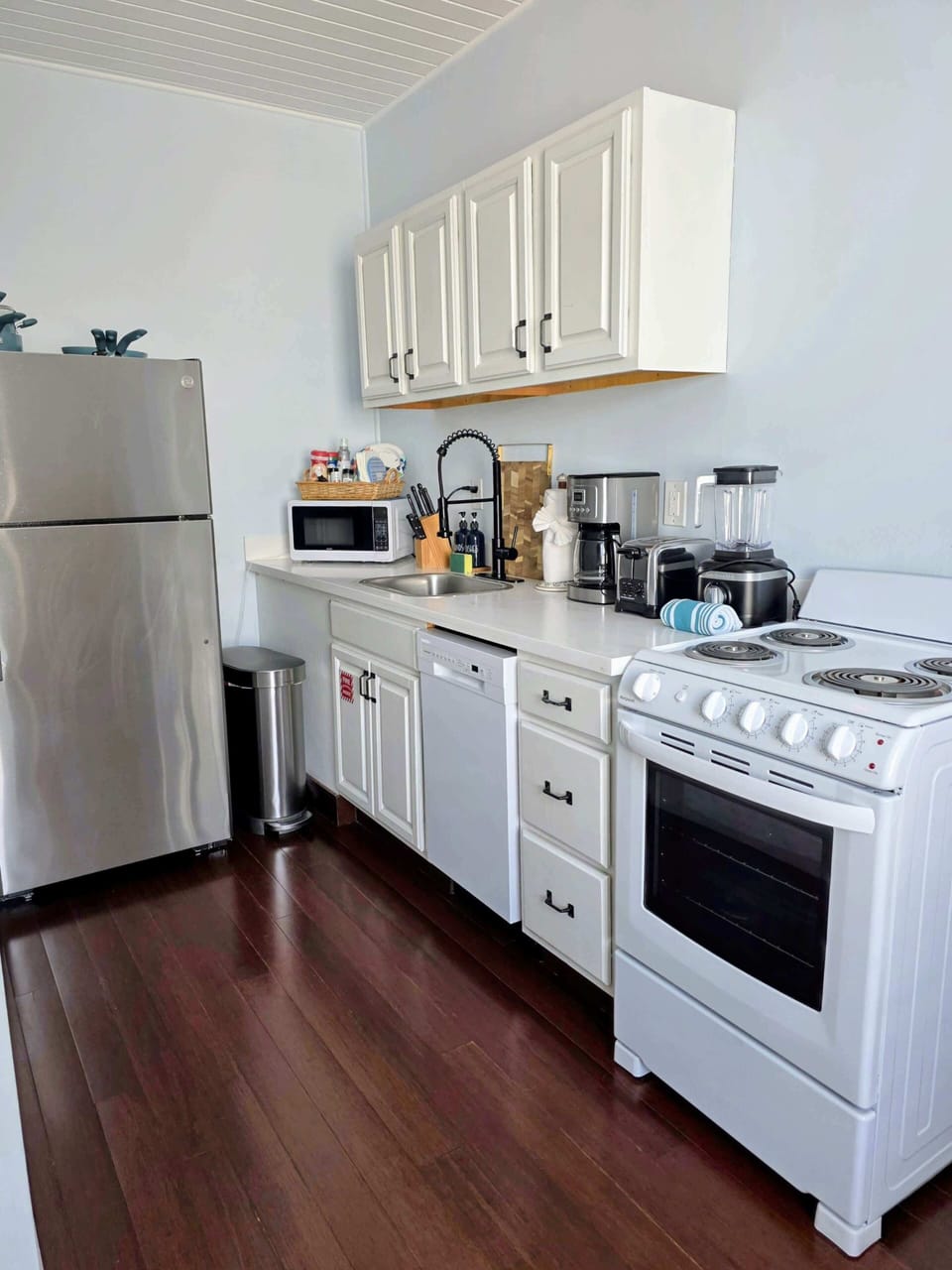 Key west suite kitchen with fridge, stove, over, dishwasher, blender, toaster, coffee maker, hand wash, dish soap and cleaning supplies