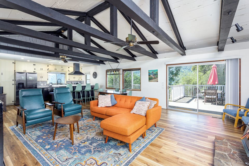 Comfortable seating with recliner chairs and couch. Slider to outdoor patio & dining space