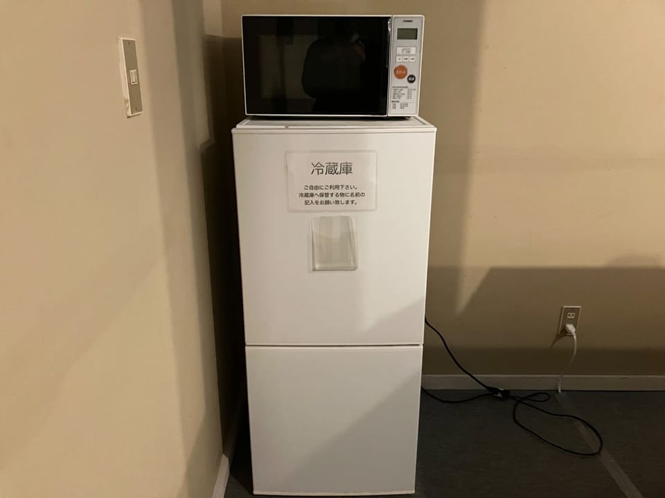 There is a shared refrigerator and microwave.