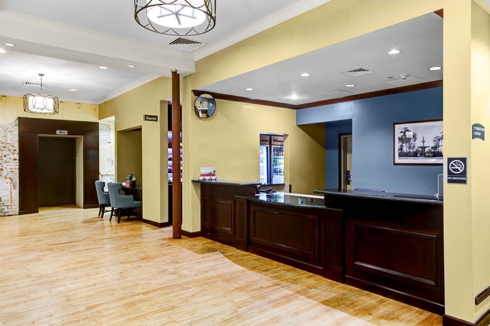 The welcoming front lobby and guest services desk with warm wood flooring.