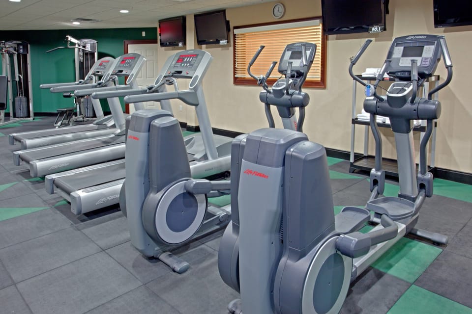 Fitness center with cardio and weight machines.