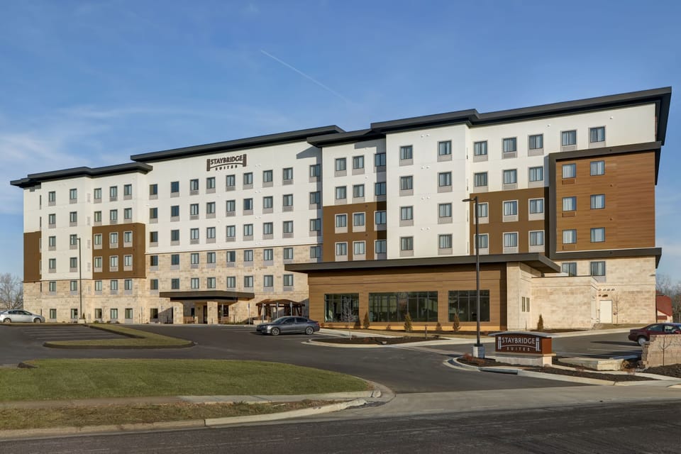 Modern multi-story exterior with landscaped entrance.