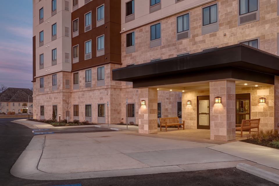 Multi-story building exterior with welcoming entrance.