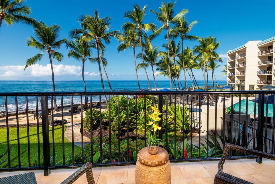 Overview of the pool and private beach. Spacious lanai overlooking the ocean, saltwater pool, and coastline — perfect for morning coffee or sunset relaxation.