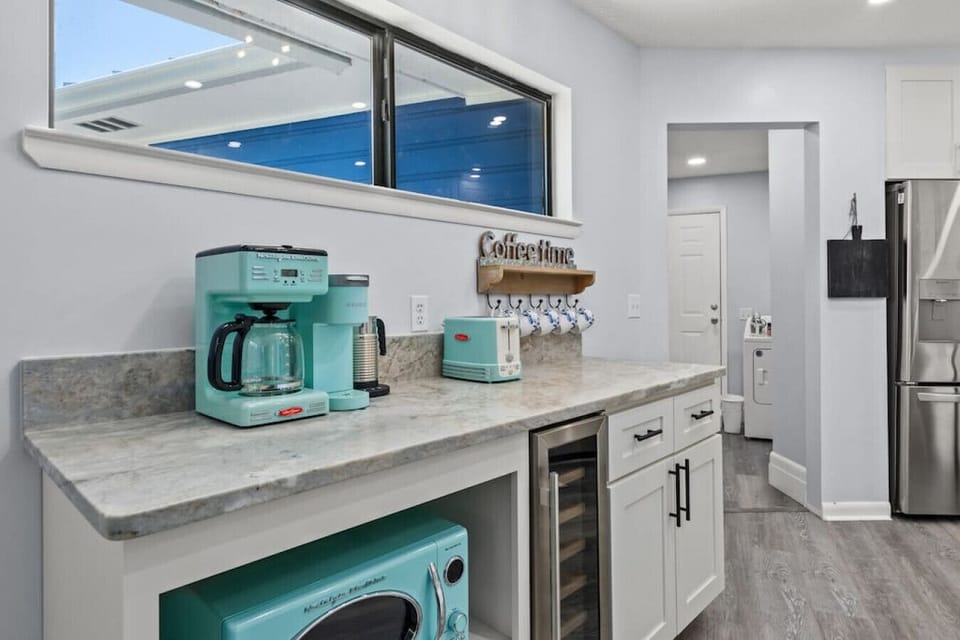 Cook, sip, and gather in this fully renovated kitchen, complete with high-end granite, modern stainless steel appliances, and a fully stocked coffee bar with retro-style appliances for a playful touch.