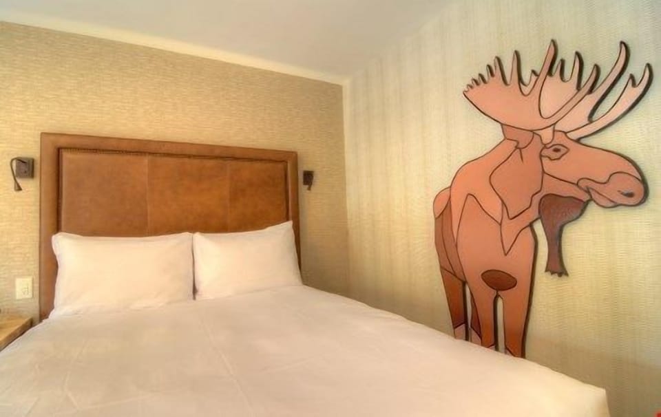 There is a luxurious king-sized bed in this bright and open room.