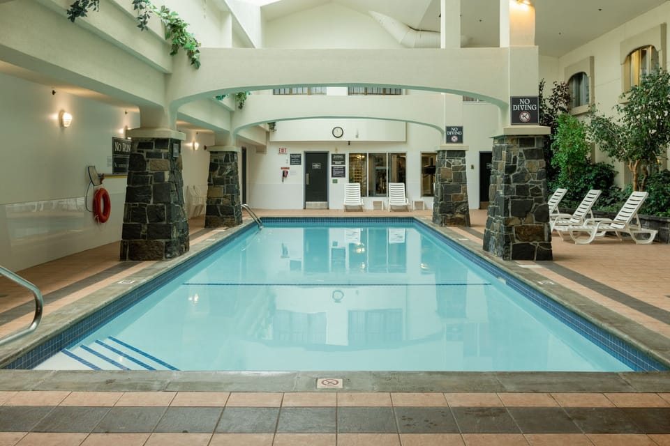 Full-length view of the indoor pool with lounge seating on both sides