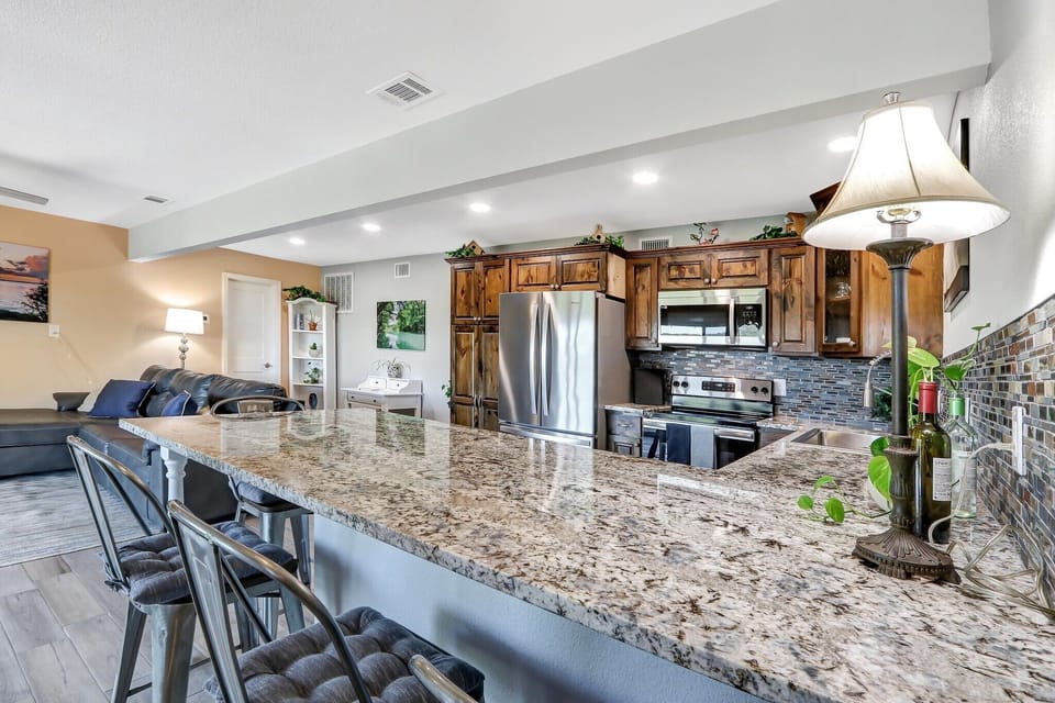Full kitchen with granite counters and stainless steel appliances