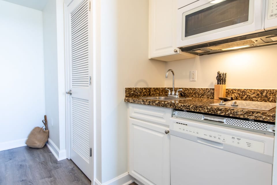 Kitchen with stove top, dishwasher, and microwave.