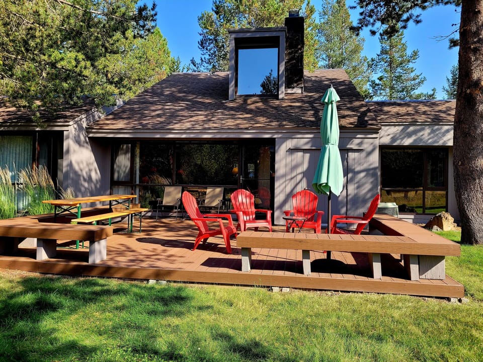 Unwind in the illuminated hot tub surrounded by natural rock features, then take a dip in the adjacent pool—all under dramatic timber beams and bright skylights.