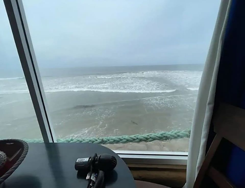 Large window in the cabin over the ocean.