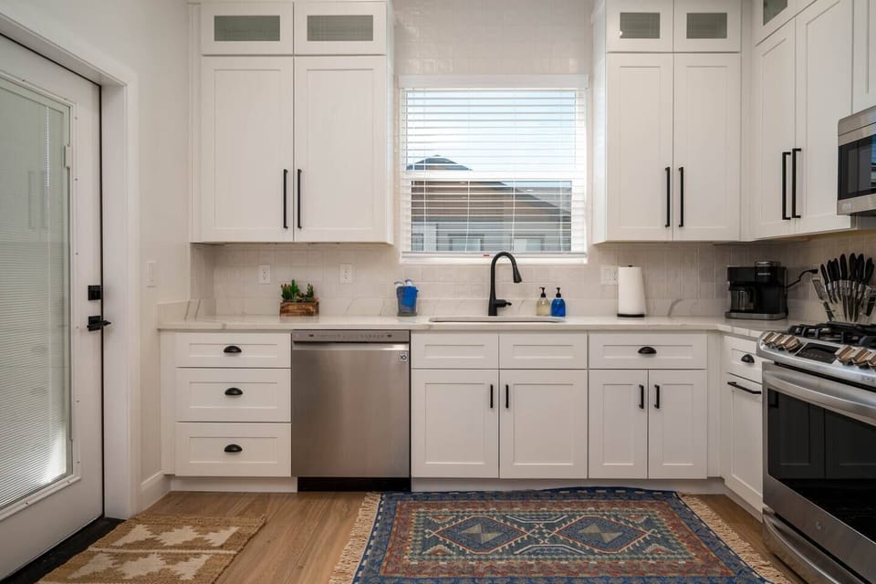 Prepare meals with ease using the provided knife set, coffee maker, deep sink, and a selection of kitchen utensils, ensuring a seamless cooking experience during your stay.