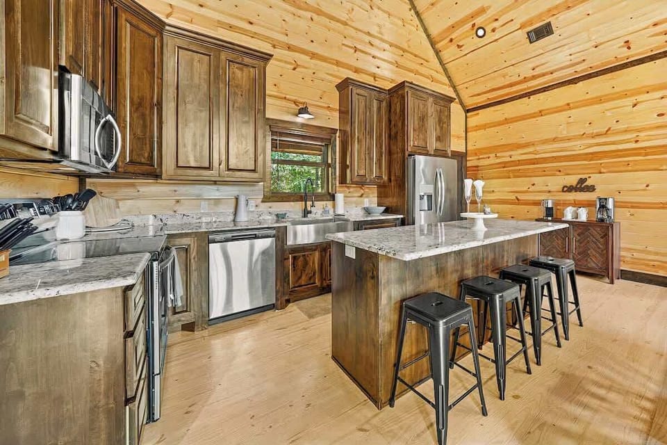 Full Kitchen with pantry staples supplied (including spices, condiments, paper towels, dish soap + more). Breakfast bar w/ seating for 4.