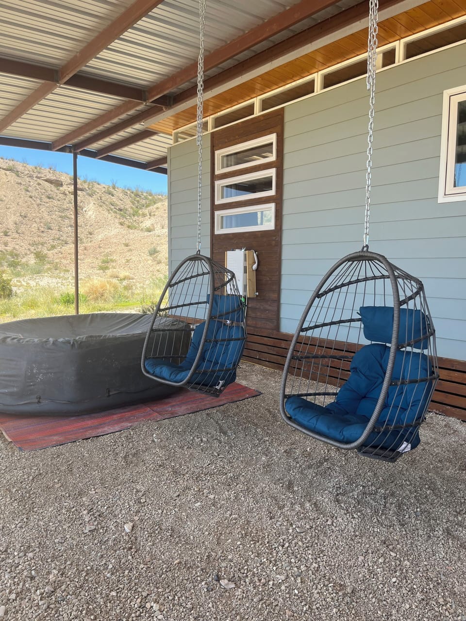 Swings and Hot Tub under covered Patio at the Modern House