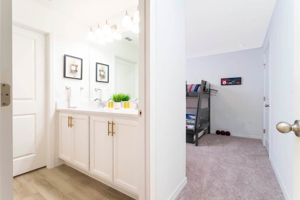 Hall bath with dual sinks sits steps from the playful kids' room featuring a twin-over-full bunk-easy mornings and cozy nights!
