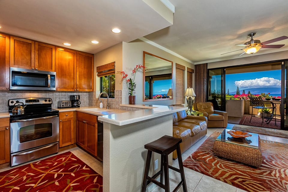 Your open-concept haven flows from kitchen to living room, with brilliant blue ocean views and a private balcony beyond. Cook, relax, and soak in tropical beauty—all from one inviting space.