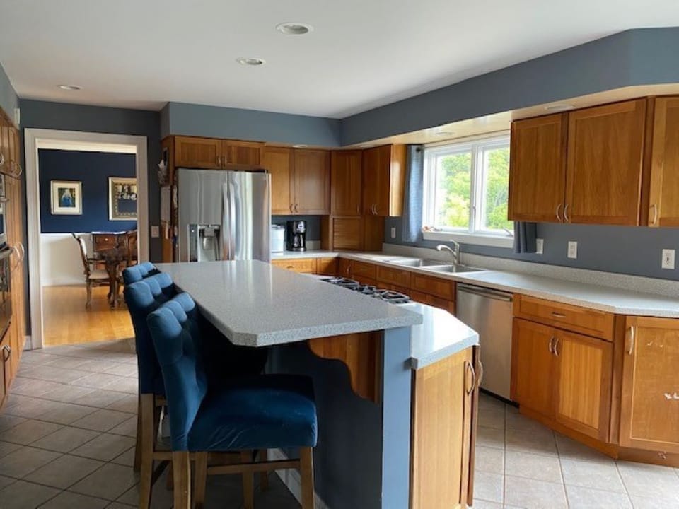 Spacious kitchen with breakfast area dining and additional seating at island. 
