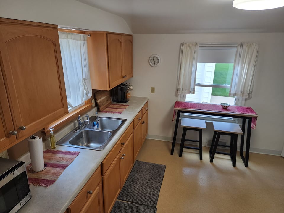 Kitchen w/ microwave, Keurig Coffee, Paper towel and plates, soaps, and sponges