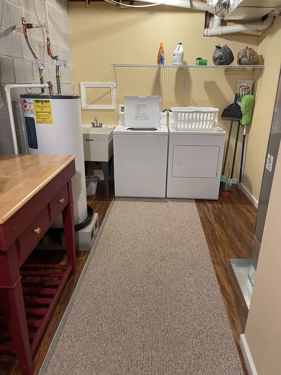 Large laundry room with wash tub and folding cart