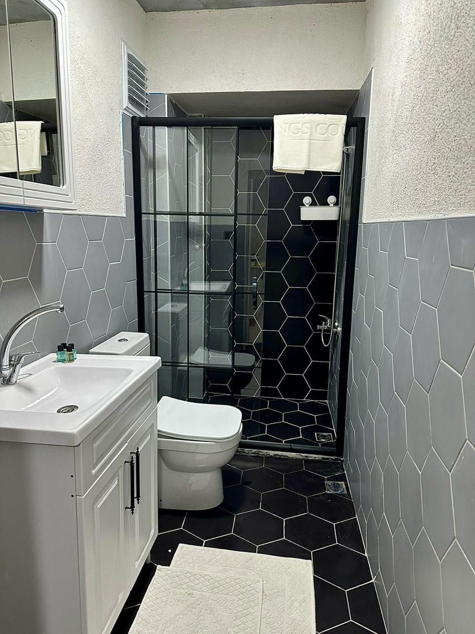 Shower, hair dryer, slippers, towels