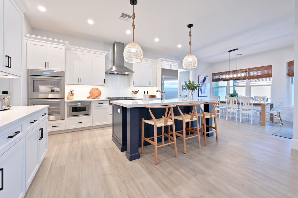Sunlit kitchen, with an island for everyone to gather around and open to the rest of the main living area.