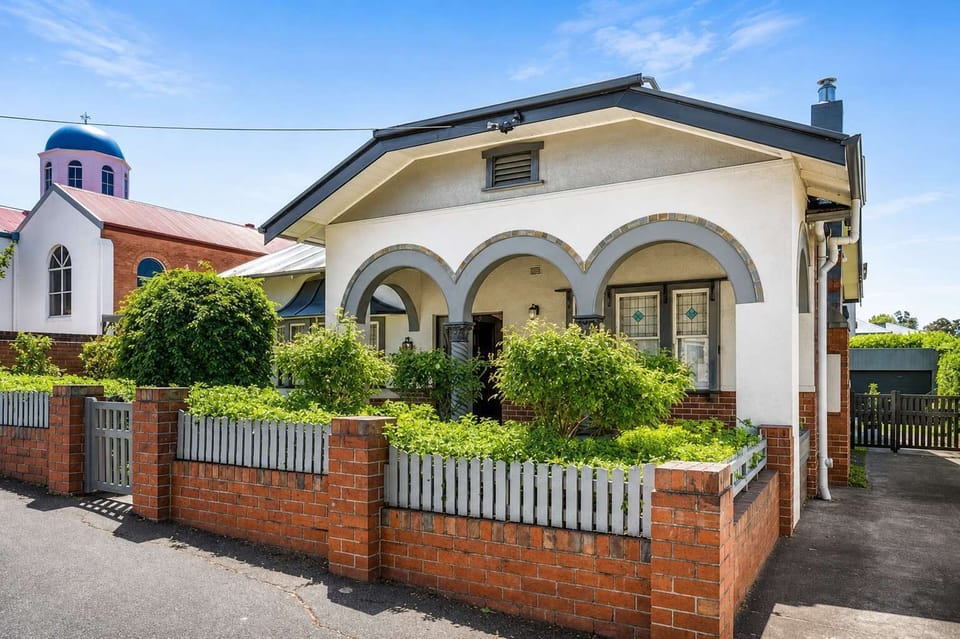 Welcome to Little Halcyon, a character-filled 1930s home with distinctive arched architecture, established gardens and convenient off-street parking.