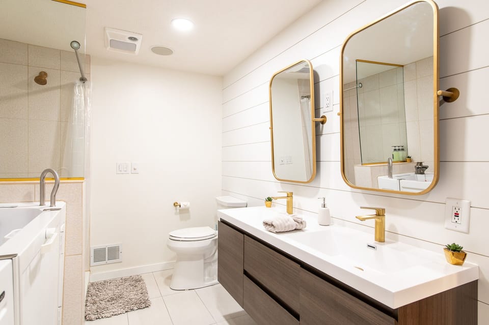 Step into your spa-like bathroom featuring dual vanities, gleaming fixtures, and a refreshing walk-in shower for ultimate comfort.
