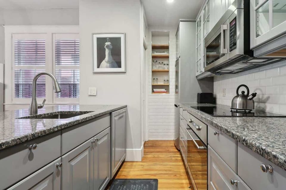The completely updated kitchen is fully equipped to whip up a meal, do laundry (small laundry closet) or create some cocktails!
