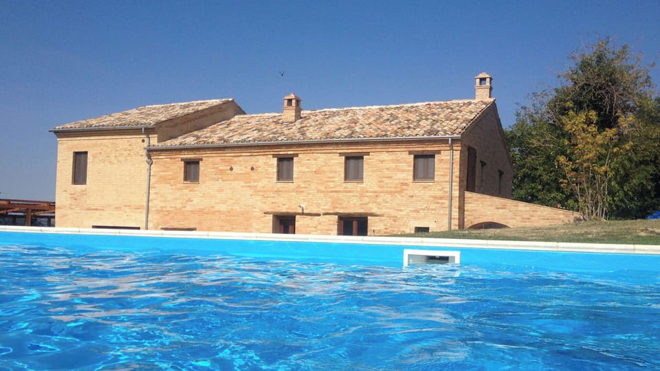 the house from across the swimming pool.  Pool now has a safety fence around it