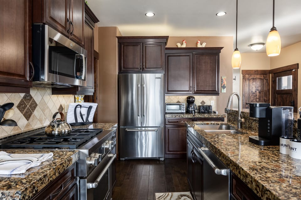 - Fully equipped kitchen with stainless steel appliances  
- Granite countertops and wood cabinetry add rustic charm  
- Perfect for cooking and gathering with family or friends