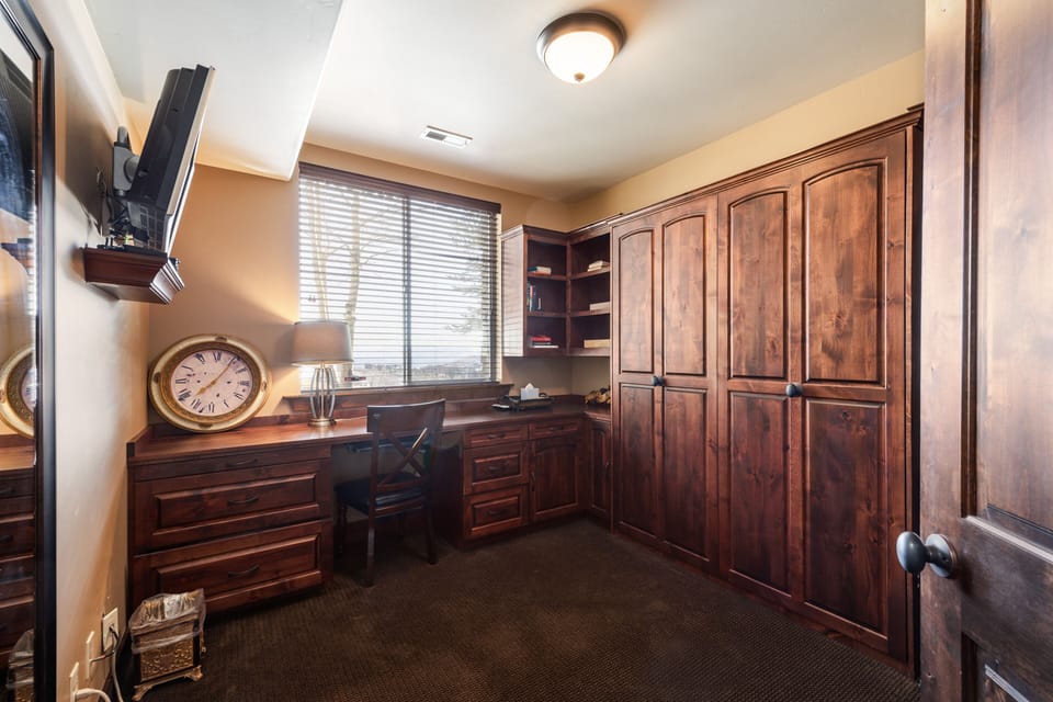 - Home office with built-in wooden desk and storage space  
- Large window brings in daylight and mountain scenery  
- Quiet retreat perfect for working or reading comfortably