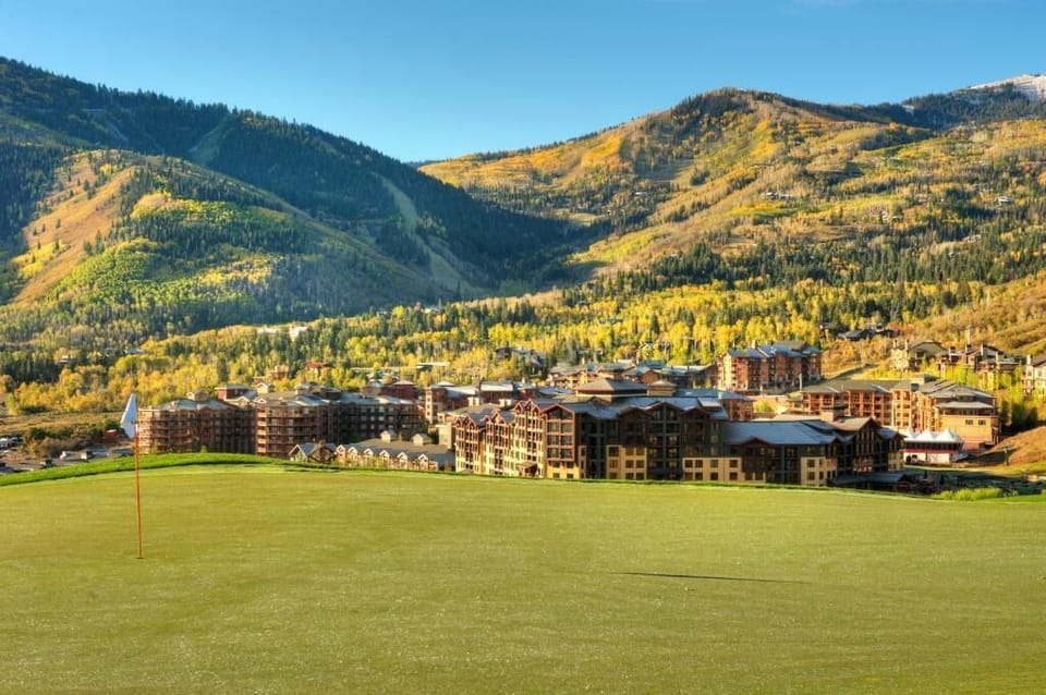 Stunning summer scenery featuring wide-open mountain views and the resort village below.