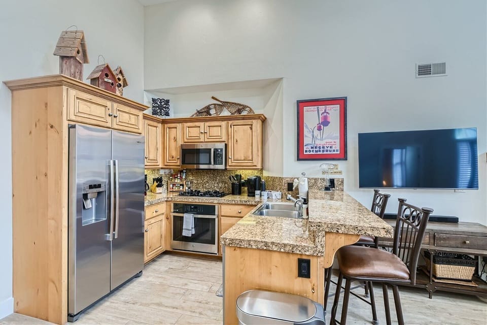 - Kitchen with granite countertops and stainless steel appliances  
- Fully equipped cooking space ideal for preparing family meals  
- Open layout flows into the cozy living and dining area
