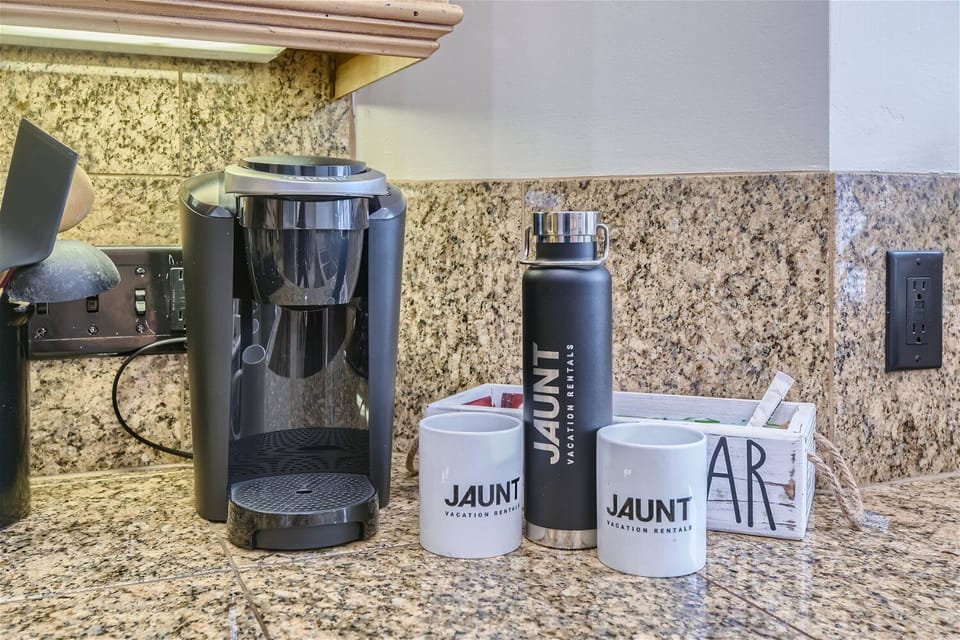 - Coffee station with Keurig, mugs, and essentials for mornings  
- Complimentary branded mugs and bottle for guest convenience  
- Start each day with fresh coffee in a fully stocked setup