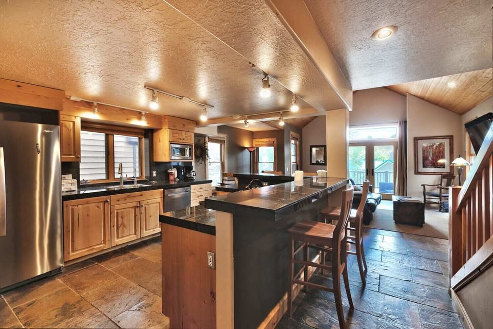 - Spacious kitchen with granite counters and bar seating  
- Fully equipped with stainless steel appliances  
- Open flow design for cooking, dining and gathering