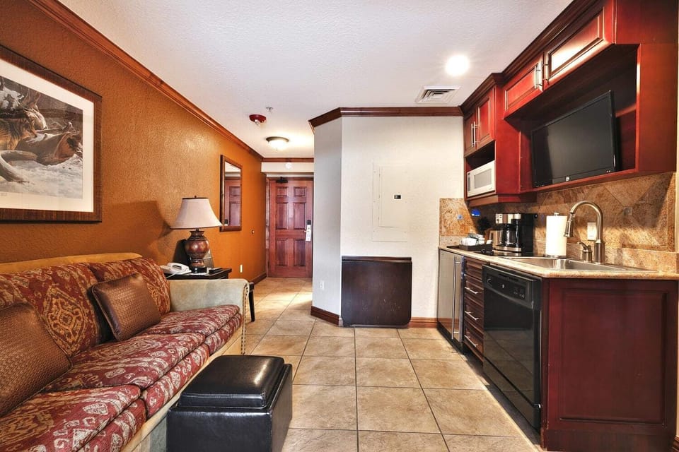 - Unwind in a compact suite with sofa and kitchen amenities  
- Microwave, coffee maker, and fridge add daily convenience  
- Cozy décor and comfortable seating create a welcoming space