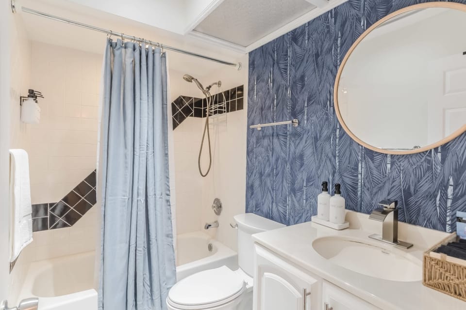 Bathroom featuring patterned tile and a fresh, airy feel