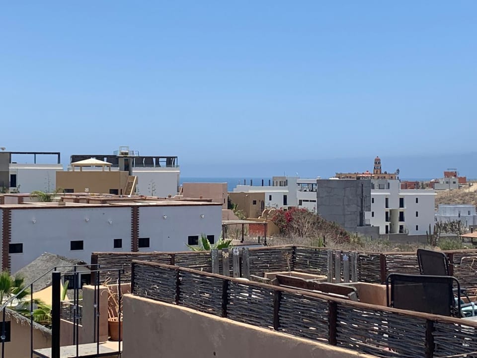 You can see the beach from the rooftop deck, accessible from the 2nd floor.