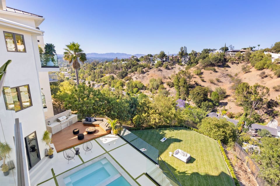 view of pool and yard from lounge room balcony
