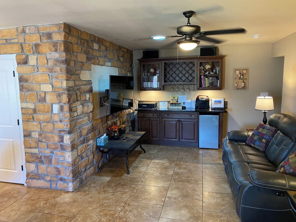 Family room with leather recliner sofa and loveseat and 55” TV