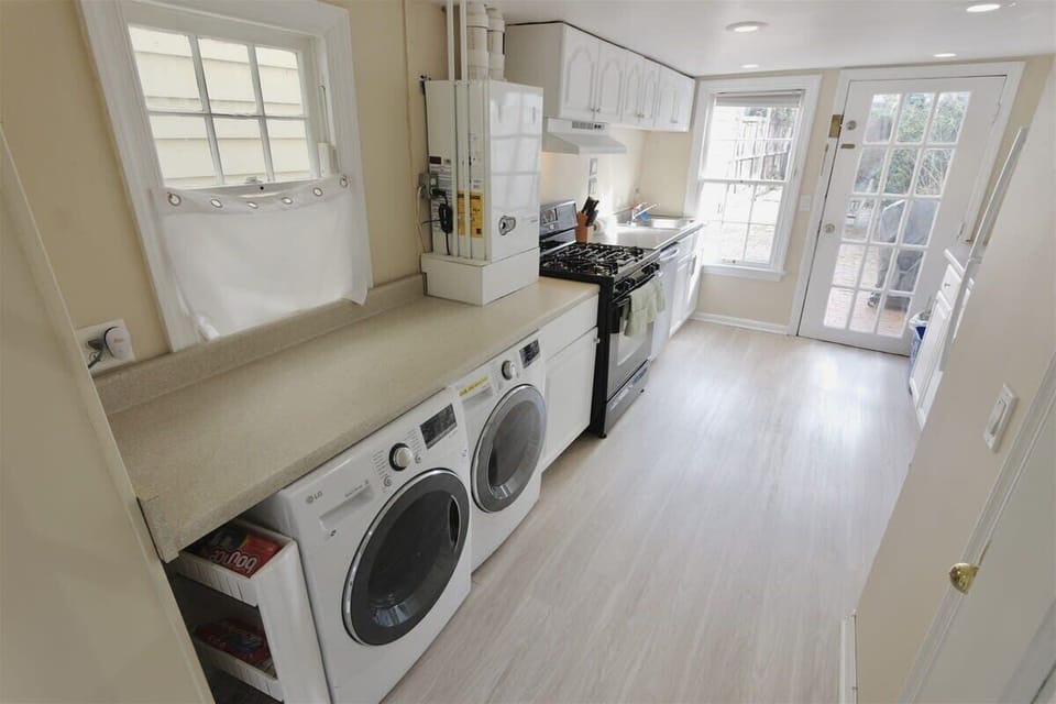 The kitchen is designed  like an English or European kitchen. Guests will have all amenities at their fingertips, and there is a washer/dryer in one section of the kitchen space (under the countertop). 